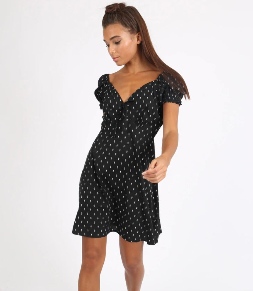 Black based white ditsy feather printed mini A-line dress with sweetheart neckline and puff sleeves