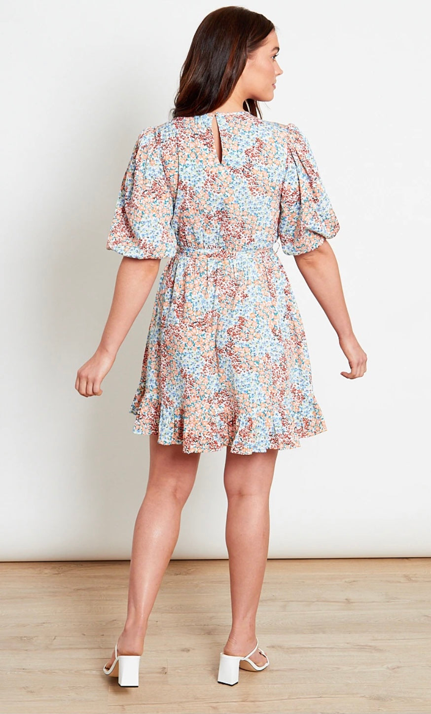 Blue multi ditsy floral printed high neck mini dress with puff sleeves, frill skirt, elasticated waist, self fabric belt and keyhole opening