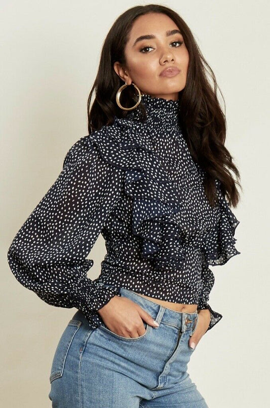 Navy based white polka dot printed high neck blouse with frill detail from shoulder to waist